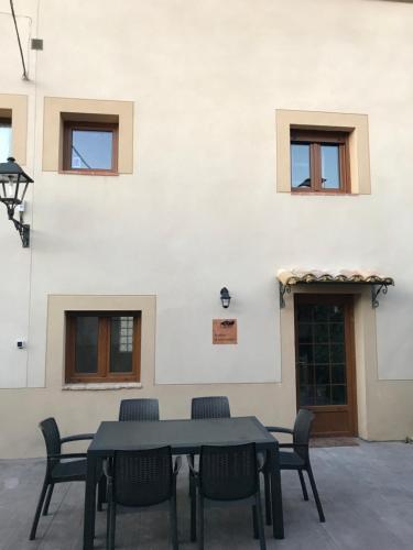 a table and chairs in front of a building at Casa la Barbacana in Barbastro