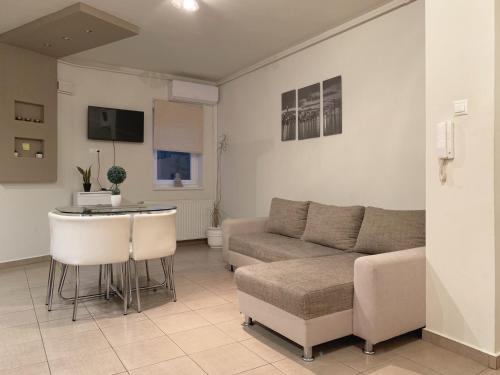 a living room with a couch and a table at St. Péter Apartman in Pécs