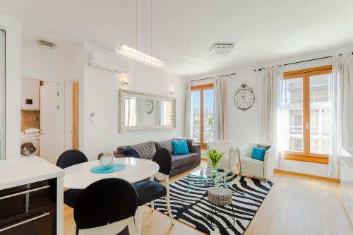 a living room with a couch and a table and chairs at New luxury apartment Nives on seaside in Split