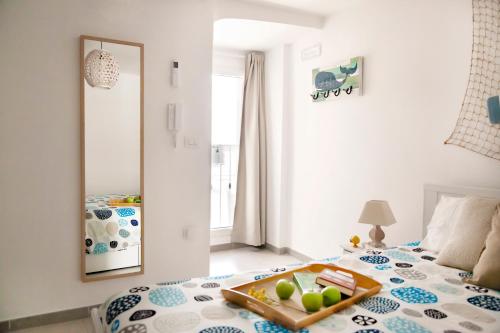 a bedroom with a bed with a tray of food on it at Il Balconcino nel Vicolo Short Lets in Polignano a Mare
