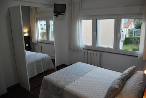 Кровать или кровати в номере Pensión Elisardo