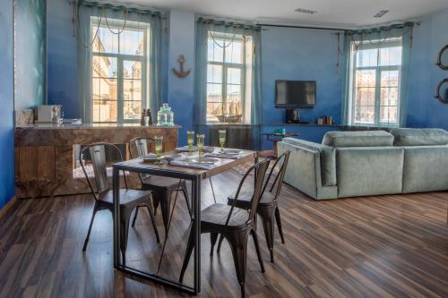 a living room with a table and chairs and a couch at Agent Flat Apartment in Saint Petersburg