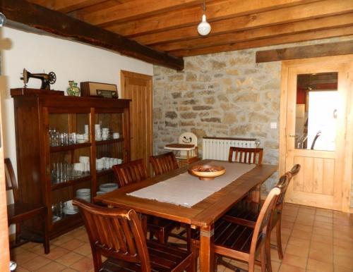 comedor con mesa de madera y sillas en La Corte del Rondiellu 1, en Bobia de Abajo