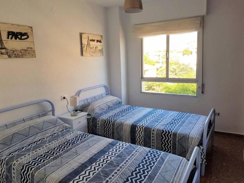 En eller flere senge i et værelse på Fantástico apartamento cerca de la playa