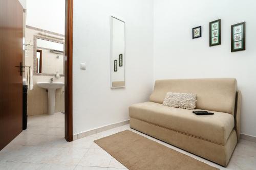 a living room with a couch and a sink at Sunrise Apartment I in Carvoeiro