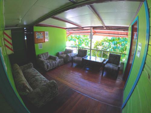 a living room with a couch and a table at Hotel Maritza in Puerto Viejo