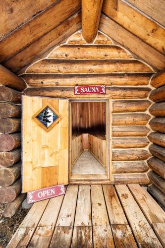 an inside of a wooden cabin with a sign on it at Hope Alaska's Bear Creek Lodge in Hope