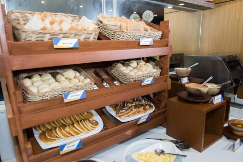 a display case with various types of bread and pastries at One Pacific Place Serviced Residences in Manila