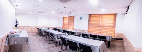 a row of tables and chairs in a room at Plea De Blanc Hotel & Residence in Busan