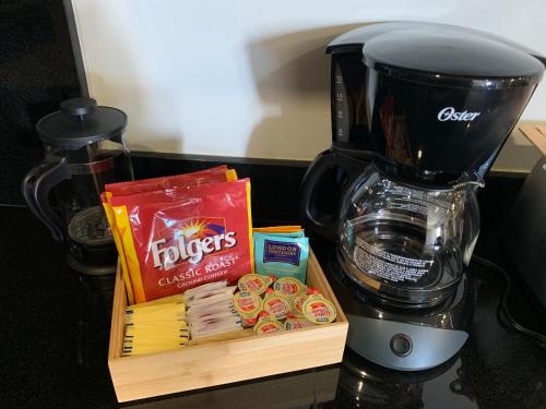 a counter with a coffee maker and a box of pastries at El Refugio in Ensenada