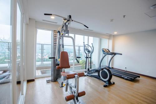 a gym with two exercise bikes and a treadmill at Bigland Hotel & Convention Sentul in Bogor