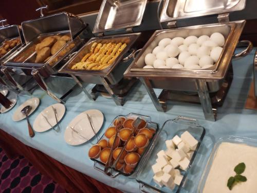 a buffet with eggs and other pastries on a table at Oriental Palace Hotel in Manama