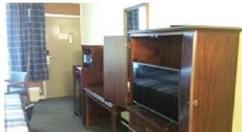a living room with a large television in a room at Travel Inn in Duffield