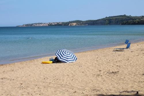 a blue and white umbrella on the beach at MAREMA 2 in Kómpoi