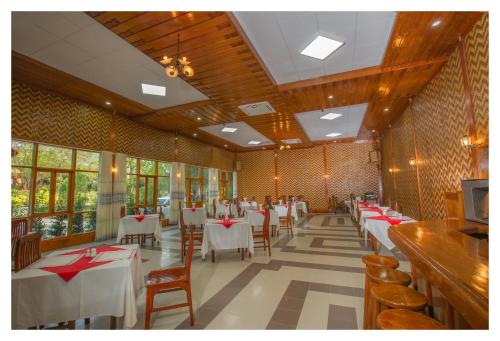 a dining room with tables and chairs in a restaurant at Ruby True Hotel in Bagan