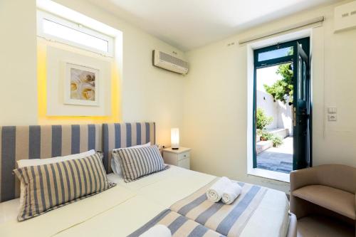 a small bedroom with a bed and a window at PRINOS in Prínos