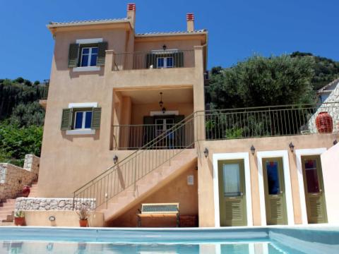 a house with a swimming pool in front of a house at Homer's View in Stavros