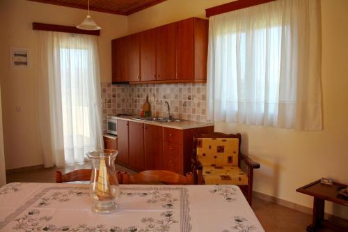 a kitchen with a table with a vase on it at ORFANOS 3 in Armenoí