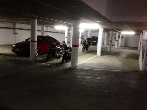 a parking garage with motorcycles parked in it at Hotel Arnal in Escalona