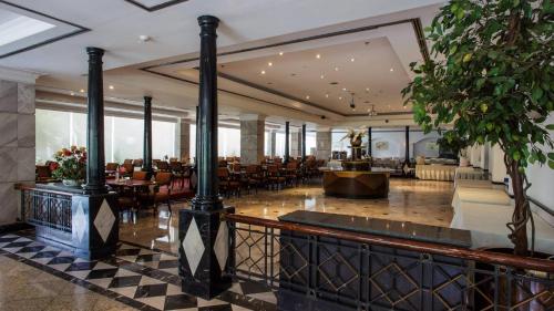 a lobby of a hotel with tables and chairs at Witz Bangkok Ramkhamhaeng in Bangkok