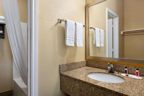 a bathroom with a sink and a mirror at Days Inn by Wyndham Port Aransas TX in Port Aransas