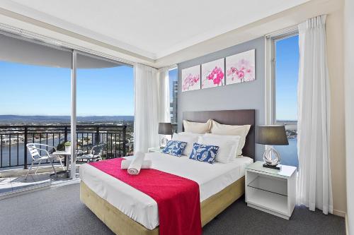 a bedroom with a large bed and a large window at Beach Stay - Ocean & Riverview resort Chevron Renaissance central Surfers Paradise in Gold Coast