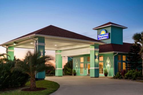 a hotel with a sign on top of it at Days Inn by Wyndham Port Aransas TX in Port Aransas