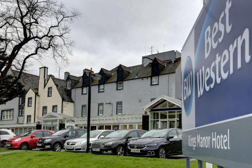 a row of parked cars in front of a building at Best Western Kings Manor in Edinburgh