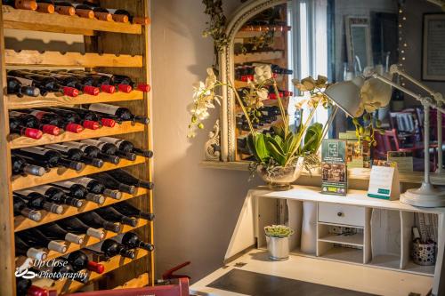 a room filled with lots of bottles of wine at The Farmers Boy Inn Guest House in Longhope