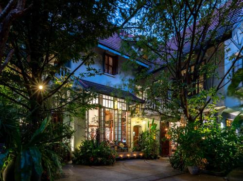 an exterior view of a house at night at Ariyasom Villa - SHA Extra Plus in Bangkok