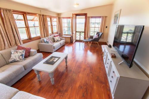 a living room with a couch and a table at Old Swanport General Store, Swanport-Murray River in Swanport