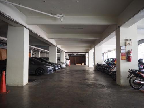 an empty parking garage with cars parked in it at Golden Crown Grand Hotel in Hat Yai
