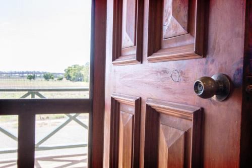 an open wooden door with a view of a field at Old Swanport General Store, Swanport-Murray River in Swanport