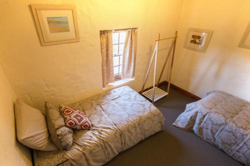 a bedroom with a bed and a window at Old Swanport General Store, Swanport-Murray River in Swanport