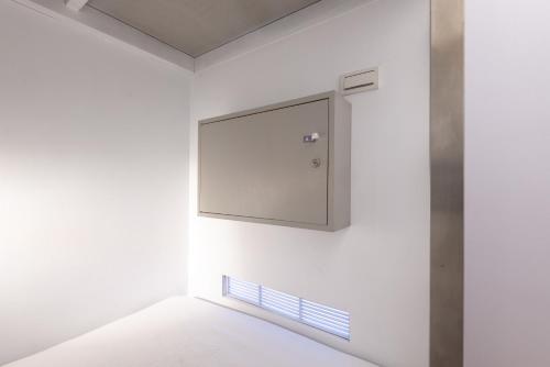 a white room with a mirror on the wall at May Rooms Taipei Main Station in Taipei