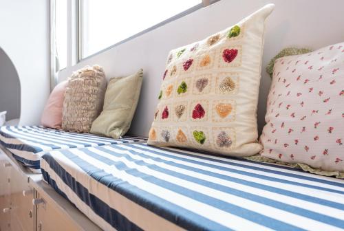 a bed with pillows on it in a room at May Rooms Taipei Main Station in Taipei
