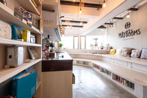 a large kitchen with a long counter and shelves at May Rooms Taipei Main Station in Taipei