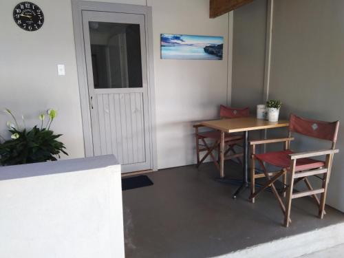a room with a table and chairs and a door at Cosy, self-contained and central to everywhere in Gold Coast