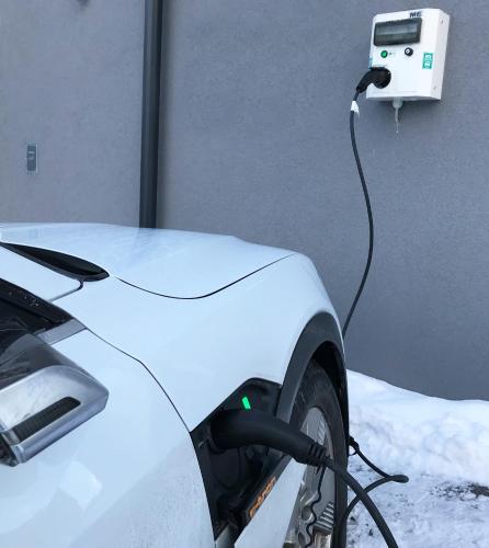 a electric car is plugged into a charger at Art Apart Nomay Summercard Blick Top of Salzburg in Kaprun