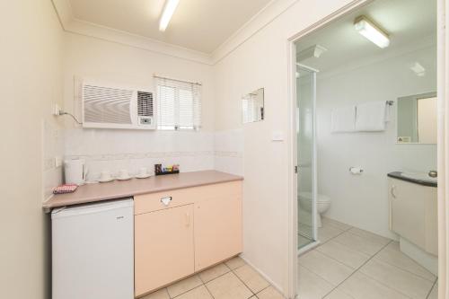 a bathroom with a sink and a toilet at Metro Motel Rockhampton in Rockhampton