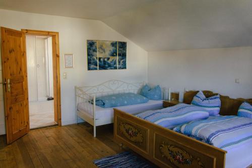 a bedroom with a large bed with blue sheets at Pension Lex in Bad Reichenhall