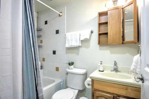 a bathroom with a toilet and a sink and a shower at Capitol Hill Luxury Apartments in Seattle