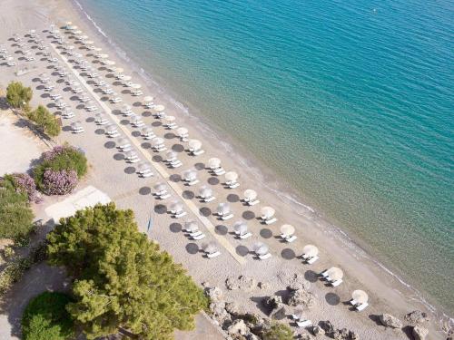 an aerial view of a beach with a bunch of cars at Lindos Mare, Seaside Hotel in Líndos