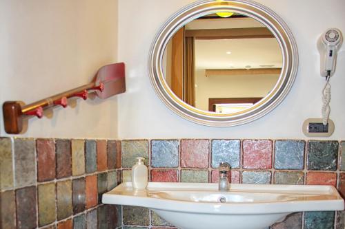 a bathroom with a sink and a mirror at Antica Stazione in Taormina