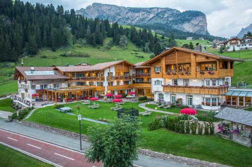 an aerial view of a resort with mountains in the background at Hotel Welponer in Selva di Val Gardena