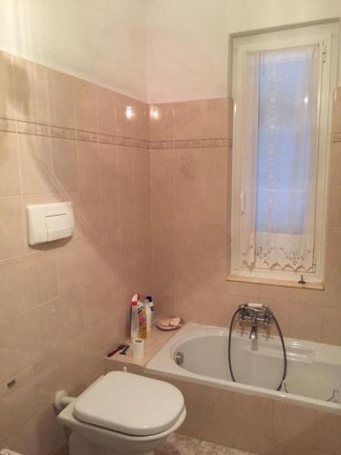 a bathroom with a toilet and a bath tub at La casa di Mirella in Ne