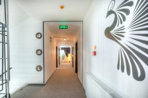 a hallway in a building with a sign on the wall at Pensiune Pavo in Piteşti