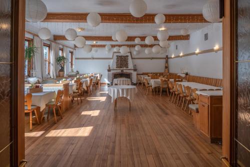 a dining room with tables and chairs and lights at Hotel Restaurant Alatsee in Füssen