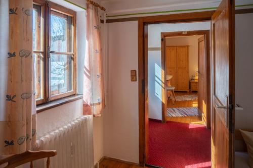 a hallway leading to a room with a window at Hotel Restaurant Alatsee in Füssen