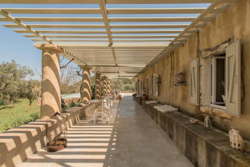 a building with a row of tables and chairs under awning at Ag Thekla Est 1924 in Skinária